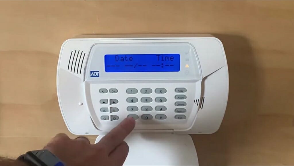 man setting up date and time for the ADT device