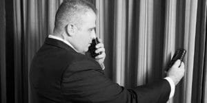 a man performing bug detector in a room