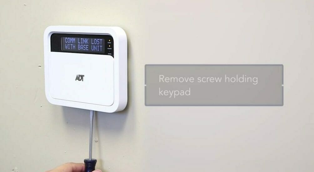 unscrewing the ADT keypad