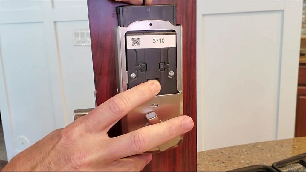man holding the kwikset smartlock