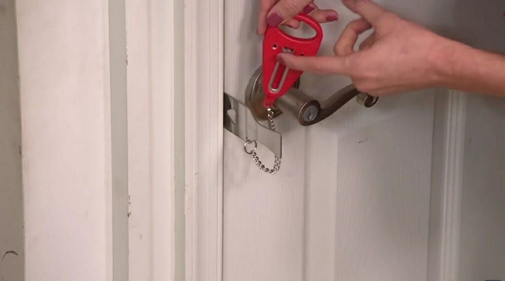 woman holding the red wedge to lock