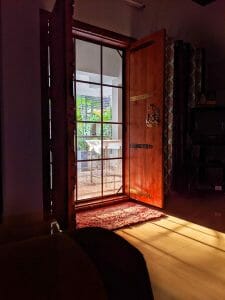 an open wood door with a screen door