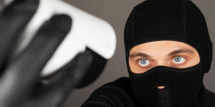 man in black disabling security camera