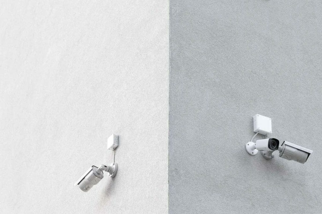 two cctv on concrete walls outdoor
