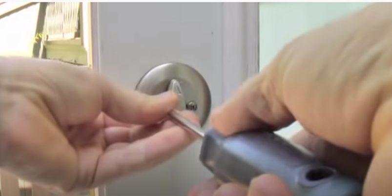 unscrewing the screws from the interior plate
