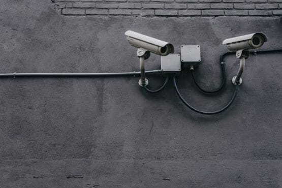 wired security camera mounted to the wall