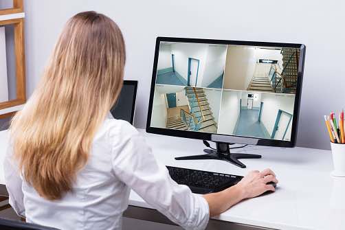 woman checking cctv camera