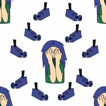 Woman hides her face with hands from surveillance cameras