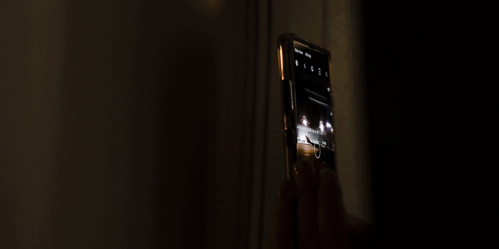 a woman's hand holding a camera phone